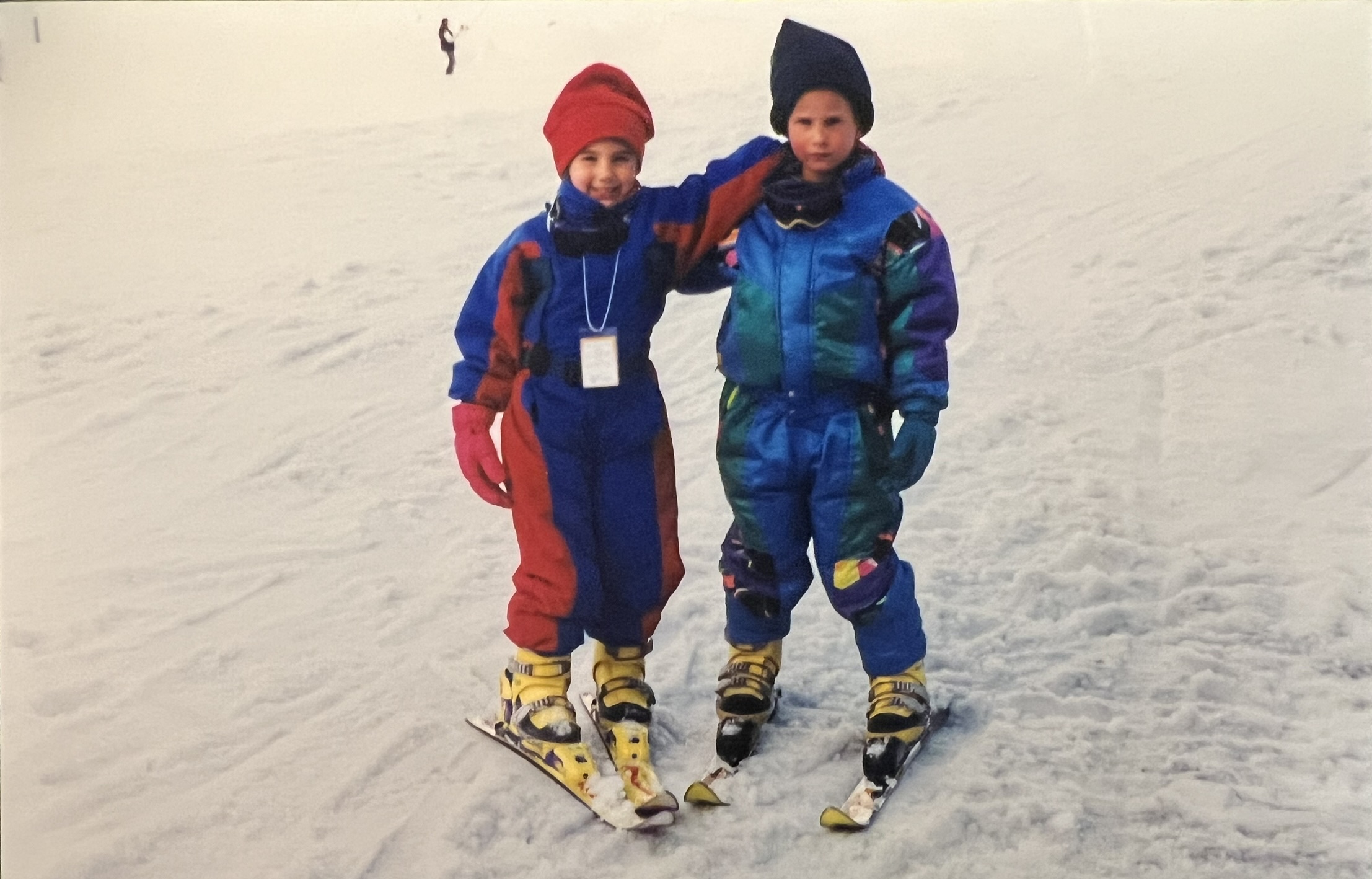 Nacho and his sister in colorful ski suits as kids
